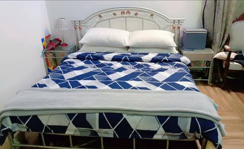 wrought iron bed | kingsized iron bed | iron bed | bed with side table