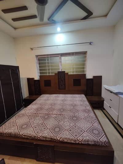 wooden bed with side tables and mattress available