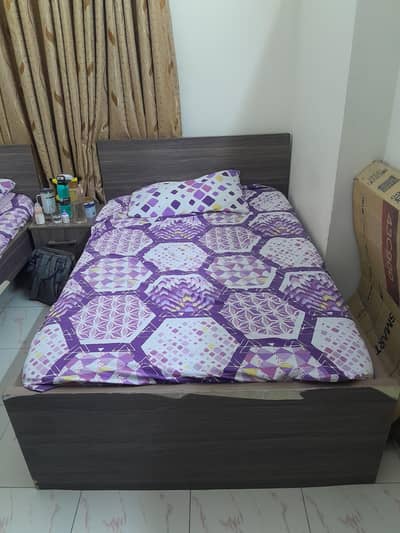 2 single beds one cupboard and 1 side table