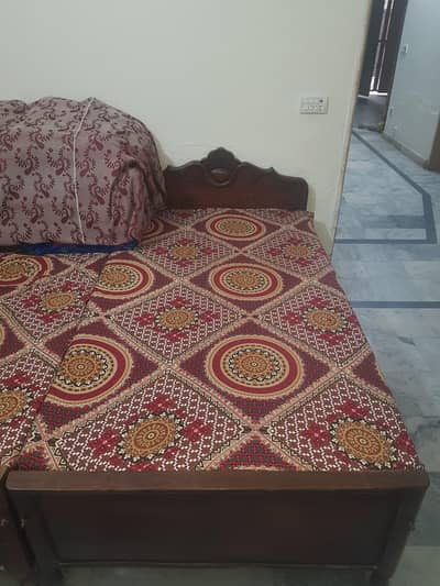 two Single Wooden beds with mattress