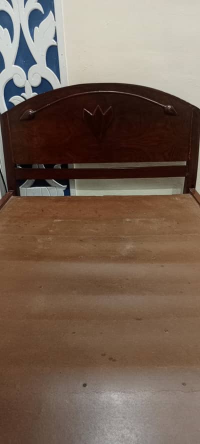 old hand made wood bed with table