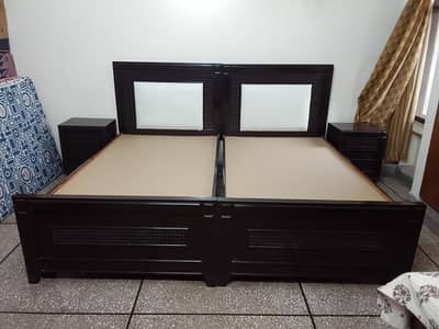 Two single beds and two side tables for sale