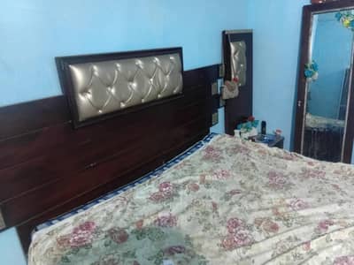 king size bed with side tables and one mirror full view