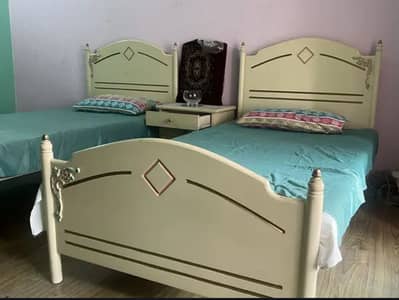 A single wooden bed without mattress