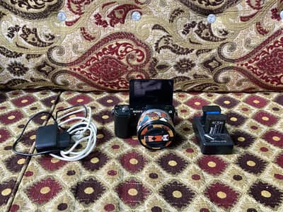 Sony a5000 with 16-50mm oss lens and accessories (only cash).