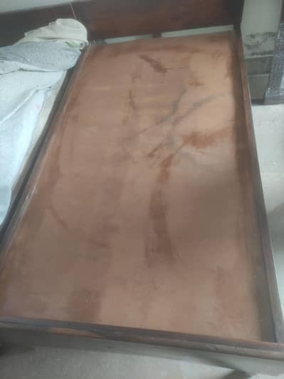 Two single wooden beds