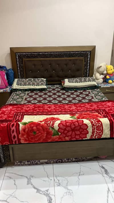 bed with side table and dressing table