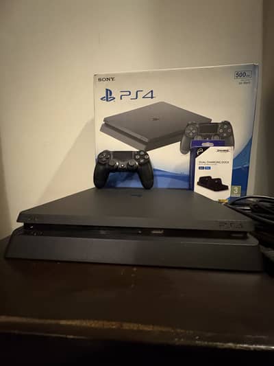 PS4 Slim 500GB. Excellent condition, with charging dock