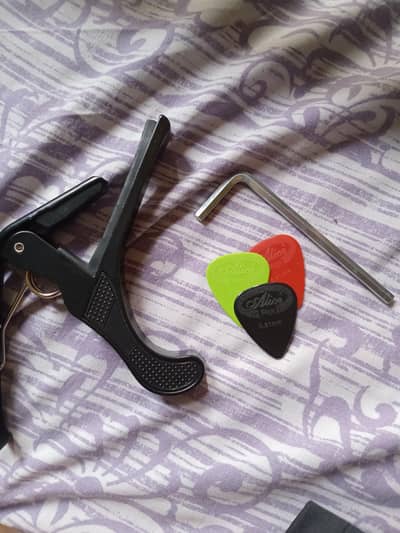 kabat guitar with 3 picks and 1 capo