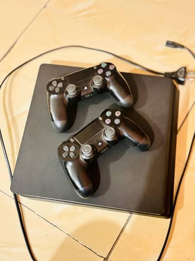 Playstation 4 slim model with 5 games and 2 controllers