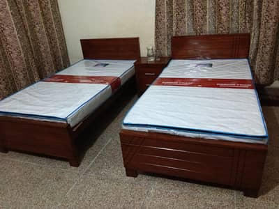 2 wooden single beds