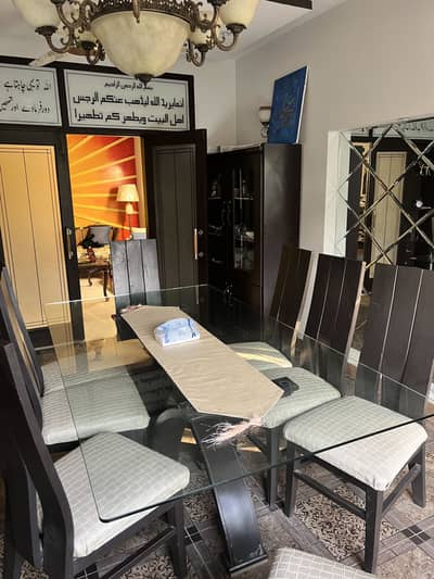 Wooden dining table with glass top