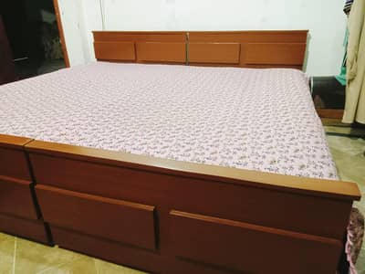 2 wooden single beds