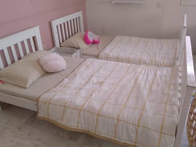 two single beds with mattresses
