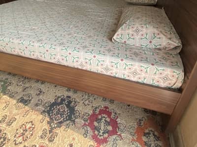Wooden bed with mattress