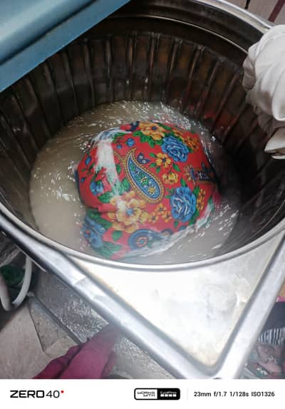 a washing machine  of metal. . . . .