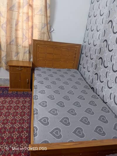 Two single bed with mattress and side table