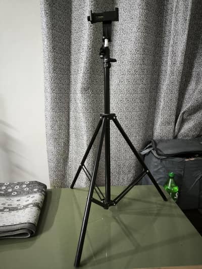 Black tripod stand for mobile and light setup