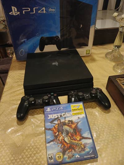 PS4 PRO 1TB WITH 2 CONTROLLERS AND 4 GAMES