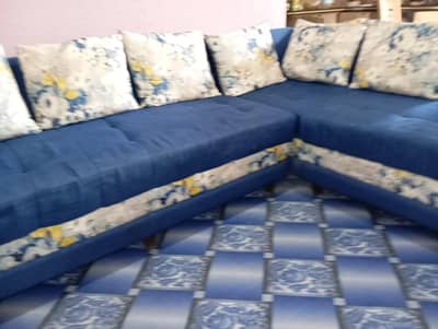blue and white L shaped sofa with side table