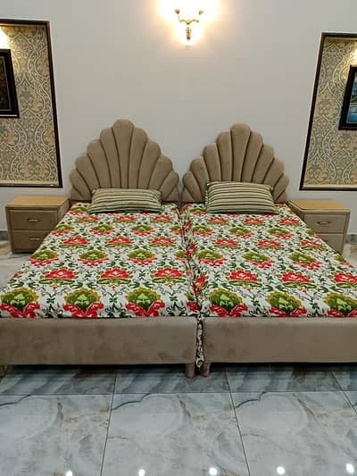 single beds with side tables and matterus.