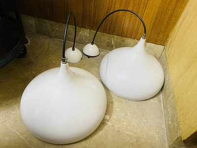 Beautiful white pendant lights designed to hang from the ceiling,