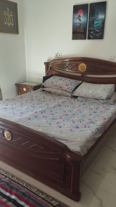 double bed with side tables and dressings table
