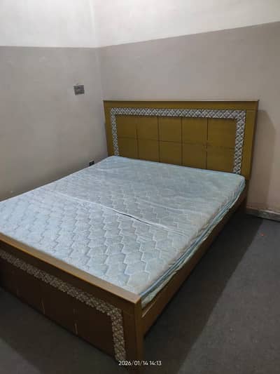 Wooden bed with mattress