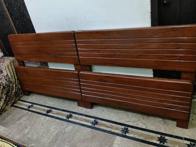 2 wooden single beds