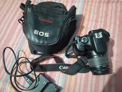 Canon 1300d with its lense and charger plus Bag
