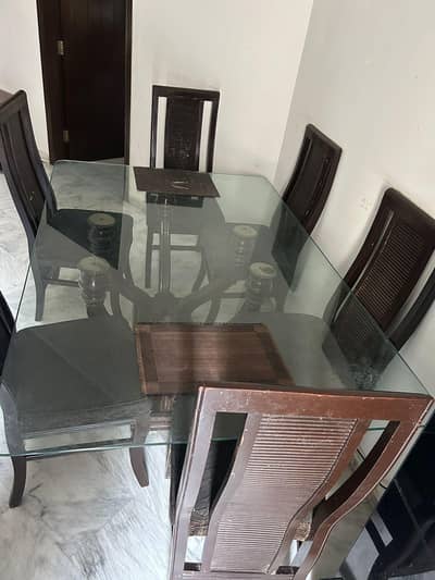 Glass top dining table 7× 4 ft with 6 chairs.