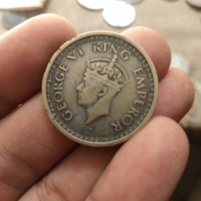 +2 This item is a 1944 British India One Rupee silver coin featuri