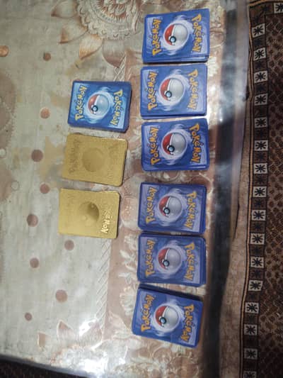 27 gold Pokemon cards and 76 random cards and common cards common cars