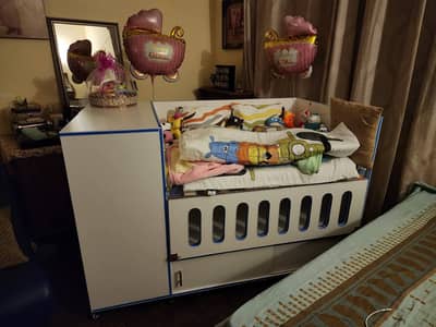 Baby cot and baby clothes wardrobe