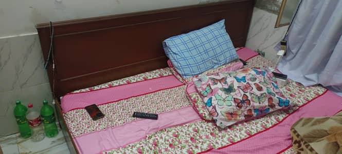 wooden bed with side tables and dressing table