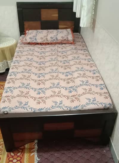 single wooden bed without mattress