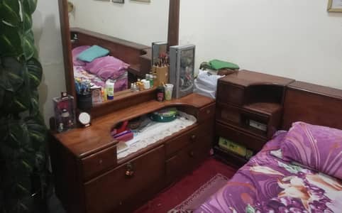 Queen size double bed wiith storage box, side tables, and dressing