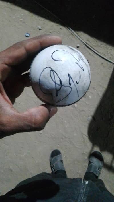 cricket ball signed by Shoaib Malik and Kamran akmal