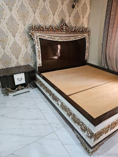 bed with side table and dreessing