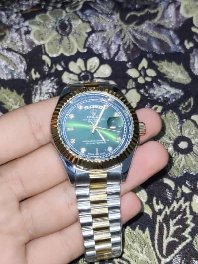Rolex watch in green dial