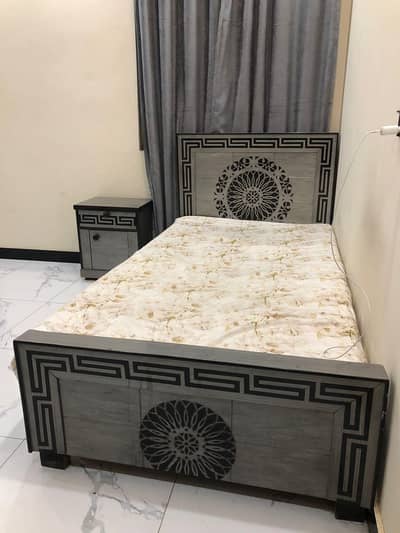 Single bed with side table and without mattress