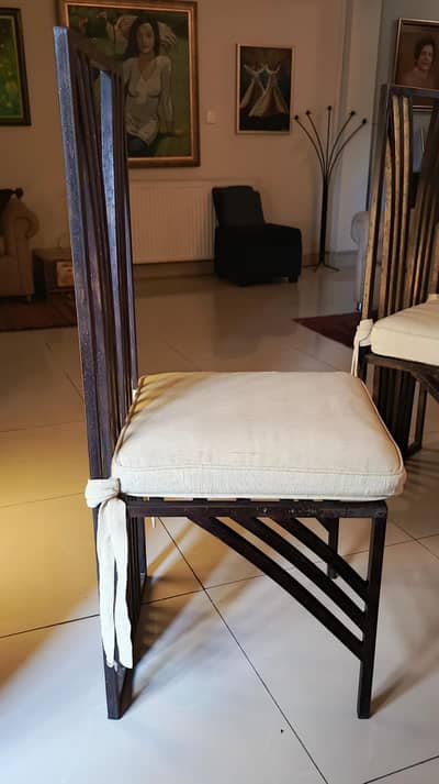 Six wrought iron dining chairs with cushions