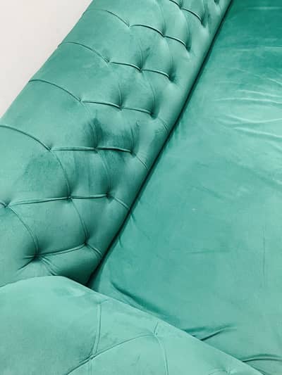 A five seater luxury green color sofa set