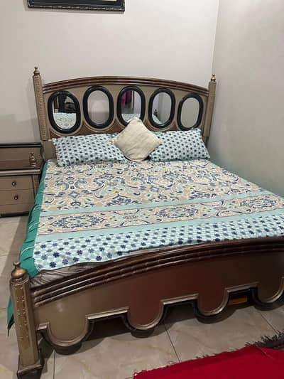 Brown wooden bed with elegant carvings