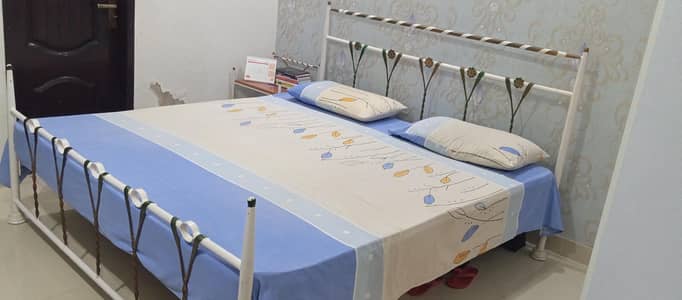 King size Iron bed with side tables and spring mattress in good condit