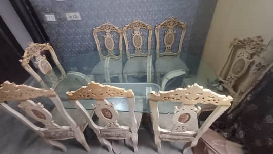 Glass top dining table with 8 wodden chairs
