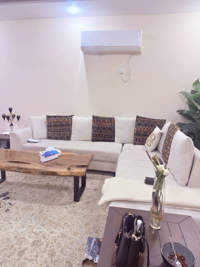 L shaped off white sofa