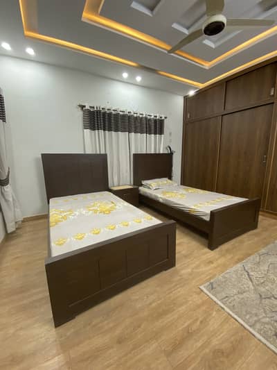 Two single beds with centre table and mattresses