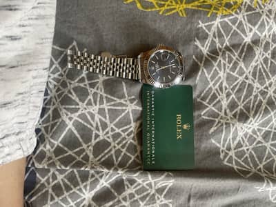 Rolex watch with warranty card and box