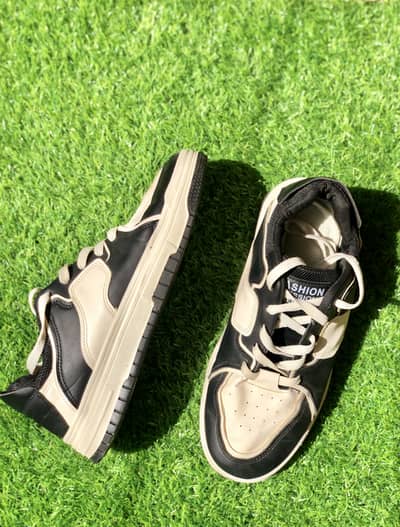 Black and white lace-up sneakers.